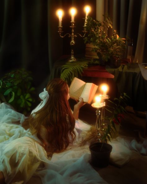 In a vintage-themed setting, a young girl is engrossed in a book, surrounded by the warm glow of candles, creating a cozy and intimate ambiance. The soft lighting highlights the details of the room and adds a nostalgic, timeless feel to the scene. Reading Vintage Aesthetic, Photography With Candles, Set Design Photoshoot, Vintage Aesthetic Photoshoot, Candle Shoot, Ribbon Photography, Set Design Photography, Candle Photoshoot, Fantasy Bedroom