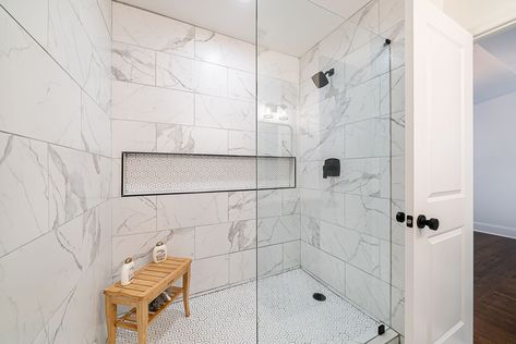 Large custom tiled shower with mosaic floor tiles and marble like 12x24 wall tile with full wall shampoo niche. Matte black bath faucets Large Tile For Shower Wall, 12 X 24 Tile Bathroom Shower Walls, Marble Tile Shower Walls, 12x24 Shower Wall Tile, Large Scale Tile, Shampoo Niche, Large Tile Bathroom, Marble Shower Tile, Scale Tile