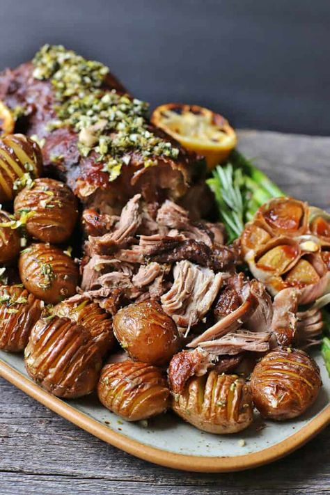 Slow Roasted Boneless Leg of Lamb - a platter filled with shredded lamb roast, mini hasselback potatoes, lemons, asparagus, and roasted garlic. Roasting A Stuffed Turkey, Roasted Boneless Leg Of Lamb, Mini Hasselback Potatoes, Greek Style Lamb, Boneless Ham Recipe, Shredded Lamb, Lamb Recipes Oven, The Best Dinner Recipes, Gyro Meat Recipe