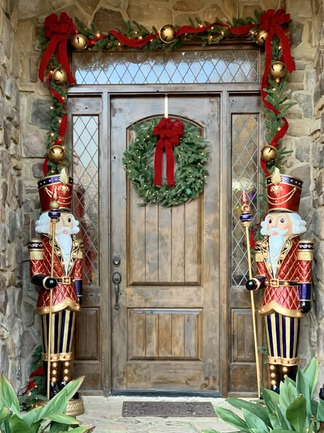 Front porch Christmas garland and nutcrackers Nut Cracker Christmas Decorations, Nutcracker Display Ideas Outdoor, Nutcracker Christmas Display, Xmas Nutcracker Decor, Tall Nutcracker Christmas, Christmas Decorations Nutcrackers, A Nutcracker Christmas, Christmas Decor Ideas Nutcracker, Christmas Nutcracker Decor