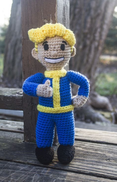 I got a custom order request for an amigurumi Vault Boy and I'm so excited that he's finished! :D I was really nervous about his face and I'm still not sure if I got it quite right, but I think it turned out cute. The design is my own, there is no pattern. Crochet Fallout 4 Patterns, Fallout Crochet Pattern Free, Fallout Crochet Pattern, Fallout Crochet, Nerdy Amigurumi, Knitted Poppy Free Pattern, Nerdy Crochet, Crochet A Bear, Vault 111