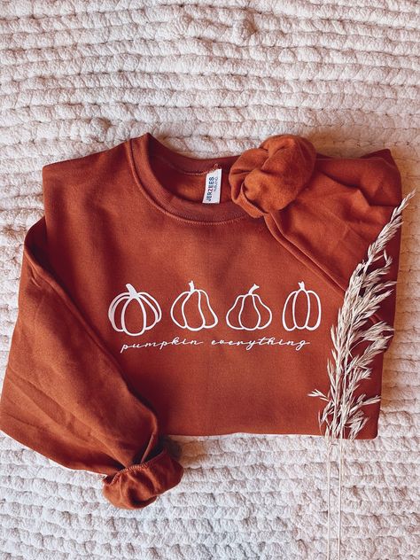 PUMPKIN EVERYTHING!! This simple pumpkin sweatshirt is the perfect cozy addition to your wardrobe this fall. Wear it out with some jeans and a beanie or throw it on with some leggings while you sip on a cup of coffee and watch all the fall/halloween movies!  - Jerzees Cotton Crewneck Sweatshirt (pictured is Texas Orange)  PLEASE NOTE: Texas Orange is currently backordered. I will keep this updated once back in stock - Siser HTV vinyl CARE INSTRUCTIONS - Wash item with like colors, INSIDE OUT on Pumpkin Shirts Women, Fall Sweatshirt Vinyl, Fall Sweatshirt Ideas, Pumpkin Everything, Pumpkin Sweatshirt, Autumn Activities For Kids, Pumpkin Sweatshirts, Fall Wear, Htv Vinyl