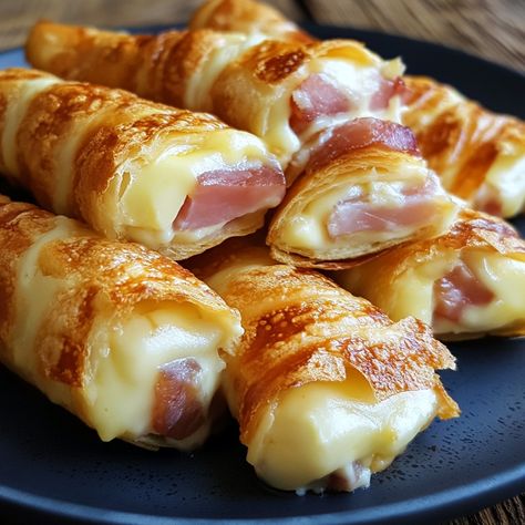 Ham and Cheese Sticks Ingredients : 🧀 200g of cheese (Gruyère, Emmental, etc.) 🥓 200g cooked ham 🥖 8 slices of sandwich bread 🥚 2 eggs 🥛 100ml of milk 🌿 A few sprigs of chives (optional) Ground black pepper Butter for cooking Instructions : 🧀 Cut the cheese into sticks about 1 cm wide and the same length as the slices of sandwich bread. 🥓 Also cut the ham into sticks similar in size to those of the cheese. 🥚 In a shallow bowl, beat the eggs with the milk. Season with ground black pepper to... Ham And Cheese Jambons, Cheese Twists, Cooked Ham, Cheese Stuffed Peppers, How To Cook Ham, Cheese Sticks, Shallow Bowl, Delicious Snacks Recipes, Retro Recipes