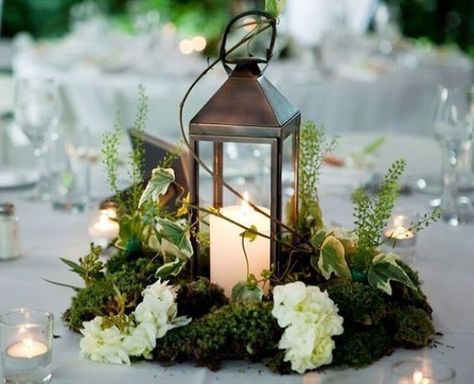 a metal candle lantern on a moss piece, with herbs and white blooms looks amazing for a woodland wedidng tablescape Wedding Ceremony Candles, Flowers Arrangements Wedding, Non Floral Centerpieces, Moss Centerpieces, Moss Wedding, Winter Floral Arrangements, Lantern Centerpiece Wedding, Ceremony Candles, Enchanted Forest Wedding