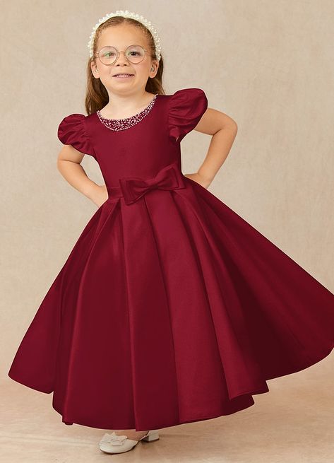 Have your flower girl dressed to impress your friends and family while she wears our matte satin little ballgown, Jewel. Her neckline is jeweled with hand sewn beading, puff sleeves, and a beautiful bow belt that sits atop a full box-pleat tea length skirt. We have matching pearls at the sleeves and a removable back bow. Satin Flower Girl Dresses, Burgundy Ball Gown, Designer Flower Girl Dresses, Silk Flower Girl Dress, Wedding Motif, Burgundy Flower Girl Dress, Tea Length Flower Girl Dress, Red Flower Girl Dresses, Fall Ball