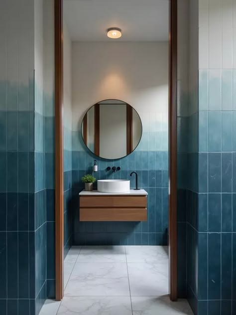 Atmospheric bathroom featuring ombre blue to white wall tiles Blue Public Bathroom, Bathroom Ideas With Blue Tile, Ombre Tiles Bathroom, Funky Blue Bathroom, Ombre Tile Wall, Blue Tile Combinations Bathroom, Ombre Bathroom Wall Tile, Blue Tile For Bathroom, Medium Blue Bathroom