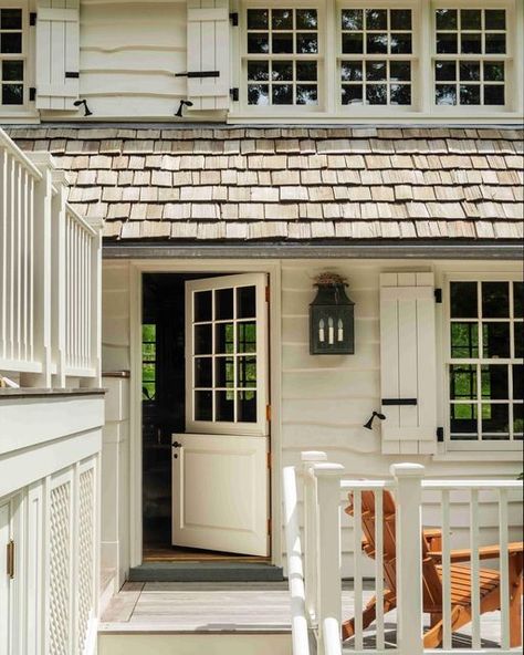 Eric J Smith on Instagram: "Nothing beats a Dutch door—here, framed by the live edge clapboard and cedar shake roof of our Country Lodge project, the door offers entry to the family kitchen. Architecture: @ericjsmitharchitect Interior Design: @ericjsmitharchitect Photographer: @durstonsaylor . . . . . #ericjsmitharchitect #ericjsmitharchitecture #exterior #exteriorarchitecture #home #countrylodge #rusticdesign #dutchdoor #northeasterndesign #backporch #cedar #clapboard #inspiration" Colonial Farmhouse Exterior, Dutch Colonial Exterior, Dutch Doors Exterior, Cottage Front Doors, Kitchen Architecture, Cedar Shake Roof, Cedar Shake, Shake Roof, Country Lodge