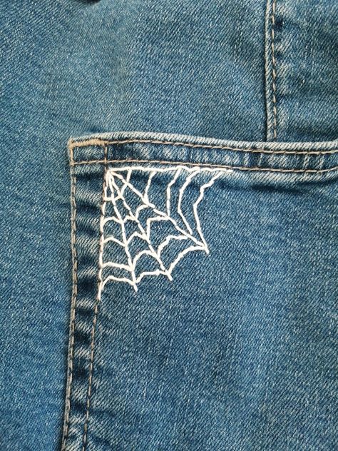 A white spider web embroidery on blue jeans pocket Embroidery On Jeans Tutorials, Jean Pants Embroidery Ideas, Easy Things To Embroider On Jeans, Jean Patches Ideas Embroidery, Embroider Spider Web, How To Embroider Spider Web, Fashion Design Embroidery, Things To Sew On Jeans, Sewing Designs On Jeans