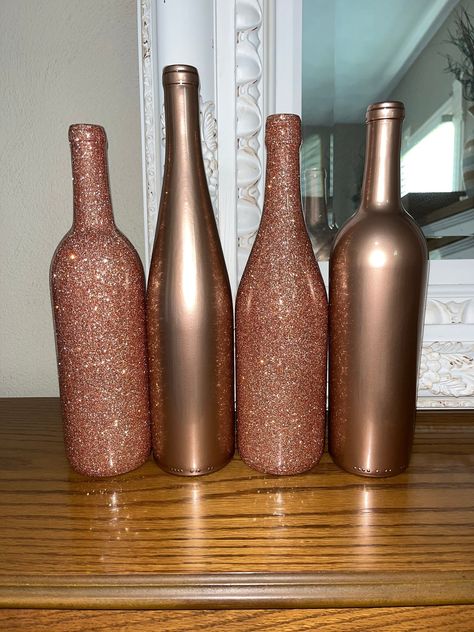 ABOUT THIS SET! -These bottles are empty glass wine bottles. All bottles are 750 ml. -This listing/price includes 4 bottles. If you would like less or more this is an option just message me before hand and let me know and I can make you a separate listing!  -These bottles consist of 2 rose gold glitter and 2 plain rose gold! All 4 bottles are coated with EPOXY, this means they do have a smooth finish and no glitter shed! The Epoxy gives all the bottles a more durable finish.  -These bottles are all different shapes and sizes, I pick these at Random and try to make them all different. If you have a preference let me know!  If you would like all of the bottles to be the same shape and size please just let me know   -All bottles are made to order so they can be made in other colors and person Rose Gold Wine Bottle Centerpieces, Alcohol Bottle Centerpieces Wedding, Diy Table Centerpieces Wedding, Wine Centerpieces, Wedding Wine Bottle Centerpieces, Wine Bottle Wedding Centerpieces, Rose Gold Centerpiece, Wedding Wine Bottle, Rose Gold Party Decor