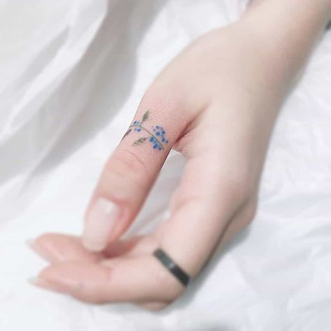 Small Finger Tattoos Bright Blue Ink Tatoo Ring, Flower Finger Tattoos, Blue Flower Tattoos, Blue Ink Tattoos, Small Foot Tattoos, Thumb Tattoos, Small Tattoos For Women, Small Finger Tattoos, Finger Tattoo For Women