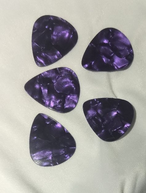 Guitar Players....picks, picks and more picks....!  Hand punched, these Purple Metallic Guitar Picks have a smooth finish and are light gauge, .48mm....  Sold 5 per pack.... Purple Electric Guitar Aesthetic, Guitar Pick Aesthetic, Purple Guitar Aesthetic, Purple Electric Guitar, Guitar Purple, Cool Guitar Picks, Guitar Pic, Descendants Oc, Purple Guitar