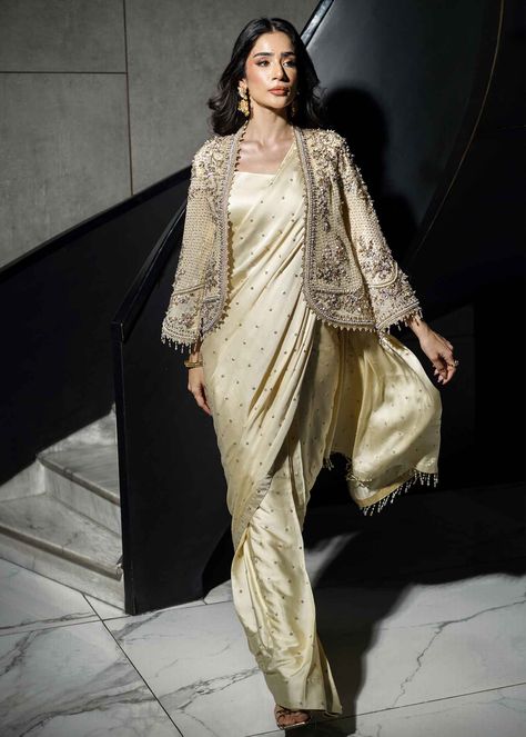 Christina – a luxurious charmeuse silk saree paired with a matching blouse and cotton petticoat, topped off with a chiffon jacket for added flair. Elevate your style effortlessly with this ensemble that exudes elegance and comfort. Perfect for any occasion, "Christina" is your go-to choice for making a statement with grace. Saree With Jacket, Drape Sarees, Party Wear Suits, Chiffon Jacket, Indian Wedding Outfit, Suits Punjabi, Saree Designs Party Wear, Saree Trends, Fancy Dress Design