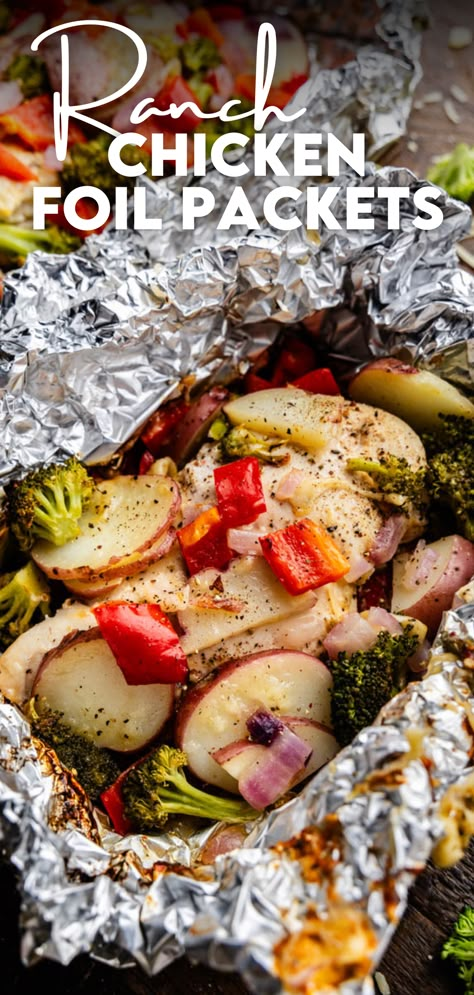 A close up view of a ranch chicken foil packet. Healthy Foil Packet Meals Ovens, Hobo Chicken Foil Packs, Foil Chicken Packets Oven, Foil Packets For The Oven Chicken, Chicken And Potato Foil Packets Ovens, Foil Dinners In Oven, Chicken Foil Packets For The Grill, Chicken Foil Packets For The Oven, Wrap Meals