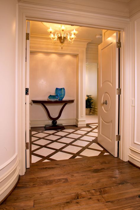 The vestibule of this penthouse is defined by a dramatic basket weave pattern created by American walnut planks inlaid with stone. The wide walnut planks provide a beautiful transition into the home’s master suite. Stone And Wood Flooring Transition, Tile With Wood Inlay, Breakfast Sunroom, Tile To Wood Transition, Bedroom Floor Tiles, Tile Inlay, Foyer Flooring, Tiles Designs, Entryway Flooring