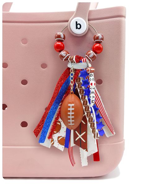 PRICES MAY VARY. 🏈 Elevate Your Style with Gridiron Glamour: Our Bogg Bag accessory combines a trendy tassel crafted from different ribbons, a football charm, and eye-catching wooden beads. This handmade bogg bag charm instantly adds a touch of gridiron glamour to any bag, making heads turn wherever you go. 💯 Premium Quality Craftsmanship: Our handmade Bogg Bag Charm is meticulously crafted using high-quality materials and detailed workmanship. From the intricately designed tassel to the durab Fabric Bag Charms Diy, How To Make A Bogg Bag Tassel, How To Make Bogg Bag Charms, Bogg Bag Ribbon Tassel Diy, Bogg Bag Keychain, Bogg Bag Baseball Charm, Bogg Bag Charms Football, Bogg Bag Charms, Bogg Bag Accessories