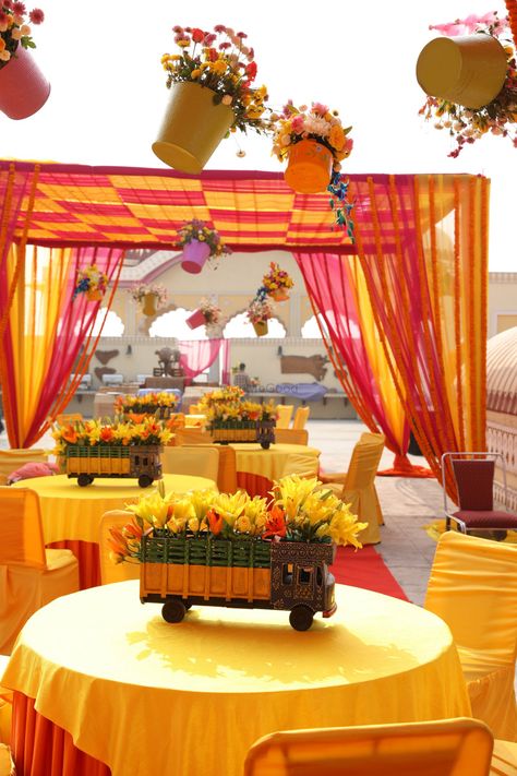 Unique hanging flower pots with mini trucks as table centerpieces in Mehendi decor| WedMeGood|  #wedmegood #indianweddings #decor #floraldecor #flowers #yellowlily #tabledecor #centerpieces #tablecenterpieces #decor #mehendidecor Haldi Decoration Ideas, Wedding Tree Decorations, Mehendi Decor Ideas, Engagement Mehndi, Photoshoot Outdoor, Wedding Shoots, Mehndi Decor, Hanging Flower Pots, Boda Mexicana