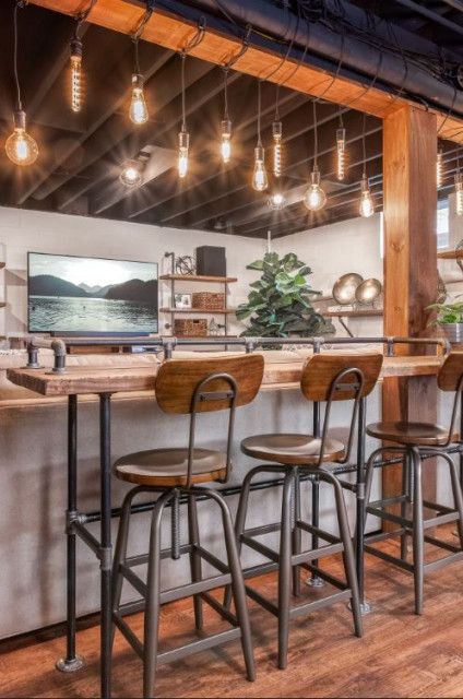 Industrial Urban Loft Basement - Industrial - Basement - Philadelphia - by Distinctive Interior Designs | Houzz Industrial Looking Basement, Industrial Basement Bar, Washington Cabin, Loft Basement, Industrial Basement, Wood Fireplace Surrounds, Game Room Ideas, Basement Decoration, Lake Property