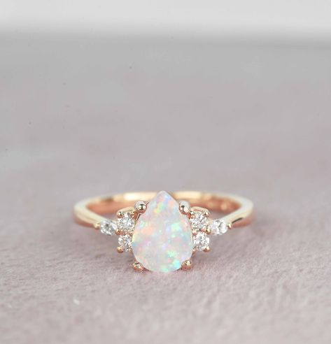 "This beautiful engagement ring is featuring   8.00mm x 6.00mm (1.52ct) center pear cut Opal and side round brilliant cut diamonds Marquise diamond set in solid rose gold.  Available (Rose gold, Yellow gold, White gold) or platinum  Free UK and USA shipping ✯✯ ✯ ✯ No Custom Charges for USA orders ✯ If you have any additional questions about this item, just hit the \"Ask a Question\" button (just to the right of the price) and I will get back to you within 24 hours.  MADE TO ORDER  Please allow 2 Engagement Rings Diamond And Opal, White Opal Jewelry, Opal Engagement Ring Pear Shape, Opal Silver Engagement Ring, Teardrop Opal Engagement Ring, Round Opal Ring, Teardrop Opal Ring, Opal And Diamond Engagement Ring, Natural Opal Engagement Ring