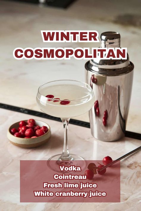 A vibrant Winter Cosmopolitan cocktail garnished with cranberries on a holiday-themed table. Cranberry Cosmopolitan Drink Recipes, White Winter Cosmopolitan, Winter Cosmo Recipe, White Cranberry Cosmo, Winter Cosmopolitan, White Cosmopolitan Recipe, Winter Cosmo, Christmas Cosmopolitan, Cranberry Cosmopolitan