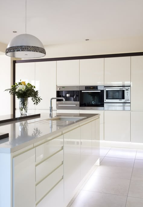 Sleek lines with this white gloss handleless kitchen and Silestone worktops. Gloss White Kitchen Island, Modern White Gloss Kitchen, Push Open Kitchen Cabinets, White Kitchen Worktop Ideas, White Kitchen White Appliances, Gloss Kitchen Cupboards, White Kitchen Diner, White Open Plan Kitchen, White Gloss Kitchen Ideas