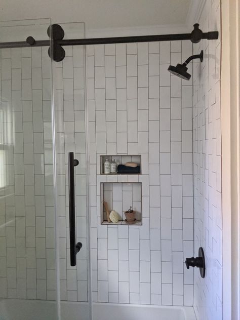 Vertical brick-set white subway tile gives this shower a modern vibe that different! White Subway Tile Shower Ideas 3x6, Subway Tile Laid Vertically, 3x6 Vertical Subway Tile Bathroom, Vertical Tiles Shower Wall, Verticle White Subway Tile Bathroom, Staggered Vertical Subway Tile, Vertical White Subway Tile, Vertical Subway Tile Shower Ideas, Vertical Tile Shower Ideas