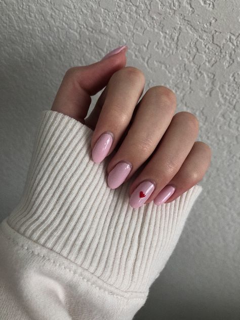 Pink Nail Red Heart, Pink Nails Valentine's Day Simple, Birthday Shellac Nails, Pink Nails With One Heart, Pink Nails With Red Heart On Ring Finger, Pink Nails With Small Heart, Short Oval Valentines Nails, Light Pink Nails With Red Heart, Single Heart Nails