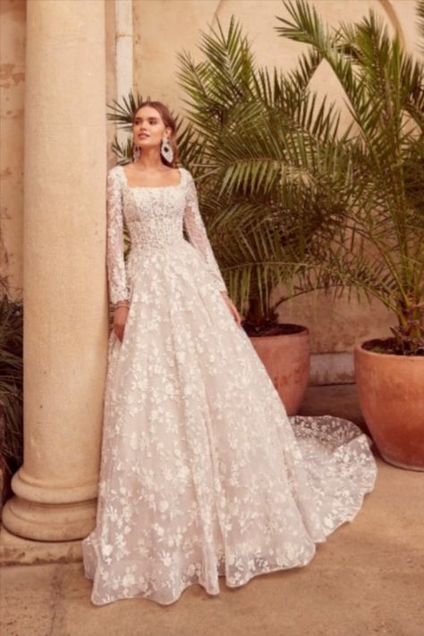 A striking floral, square neck, ballgown wedding dress, perfect for any bride wanting to make a statement.

With gorgeous lace detailing the entire dress, down to a stunning train, which effortless glide behind the bride.

Complete with detachable sheer floral sleeves, this dress is ideal for a magical winter wedding. Floral Ballgown, Square Neck Wedding Dress, Long Sleeve Bridal Gown, Bride Attire, Ronald Joyce, Wedding Dresses Uk, Wedding Dress Lace, Applique Wedding Dress, A Line Wedding Dress