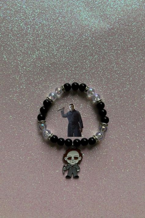 Embrace your love for classic horror with this striking Michael Myers beaded bracelet! Featuring black and clear beads with shimmering silver crystal spacers, this bracelet is the perfect tribute to the iconic Halloween slasher. The detailed Michael Myers charm adds a spooky, bold touch, making it an ideal accessory for horror movie fans and Halloween enthusiasts alike. Handmade with care, this bracelet makes a great gift or a unique addition to your collection. Perfect for everyday wear or spec Horror Movie Bracelets, Horror Movie Beaded Bracelet, Halloween Slasher, Beaded Decor, Kandi Inspo, Kandi Ideas, Horror Lovers, Kandi Bracelets, Clear Beads