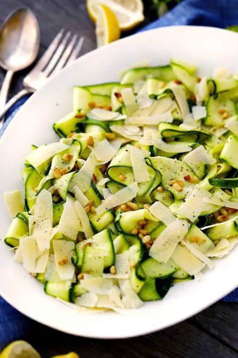 This Zucchini Ribbon Salad recipe is a wonderful way to eat raw zucchini- the ribbons are tossed with a creamy lemon olive oil dressing and topped with shaved parmesan cheese and toasted pine nuts. #zucchini #salad Zucchini Ribbon Salad, Lemony Dressing, Zucchini Zoodles, Ribbon Salad, Vegetarian Substitutes, Shaved Parmesan, Zucchini Ribbons, Resep Salad, Zucchini Salad