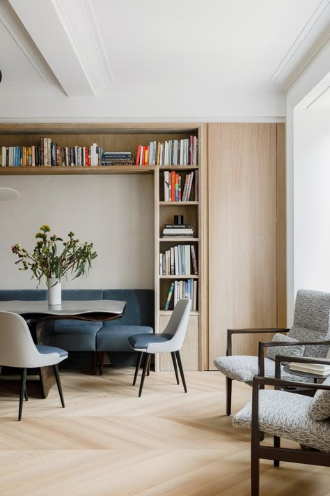 Within this dining room, chairs fit perfectly within the surrounding millwork, allowing them to act as a bench or break apart into chairs. Built In Bench In Dining Room, Narrow Dining Cabinet, Dining Room Banquette Bookshelves, Under Window Bench Dining Room, Dining And Study Combo, Dining Room Study Area, Wardrobe In Dining Room, Dining Nook Cabinets, Dining Bench And Chairs