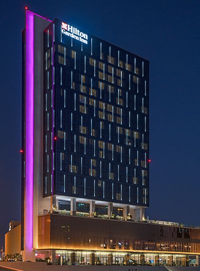 Nulty - Hilton Garden Inn Bahrain Bay - Striking Lighting Design Scheme Hotel Exterior Facade Monolithic Architecture Lighting Facade Exterior, Hotel Design Exterior, Building Facade Lighting, Facade Lighting Design, Monolithic Architecture, Commercial Building Plans, Exterior Lighting Design, Hotel Facade, Exterior Facade