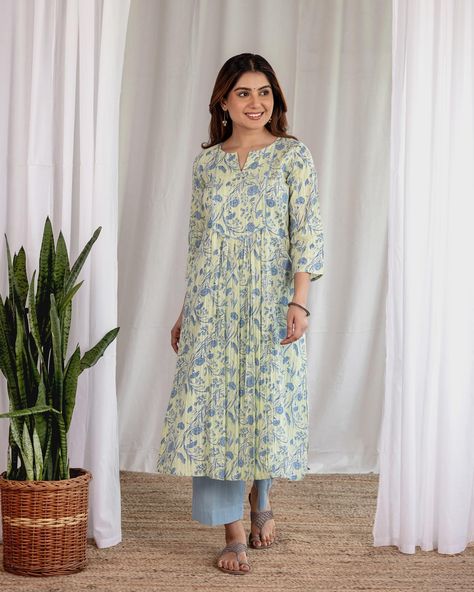 Summer Collection - New Arrivals! The ‘Blue Carnations Kurta’ features a soft play of pale yellow and powder blue. With serene florals and soothing shades, delicate pleats mimic the natural folds of carnation petals, adding texture and fluidity to the kurta. Shop the ‘Chandani’ edit on www.cottonsjaipur.com. [ Cottons Jaipur, Cotton, Carnations, Floral, Handmade Kurtas, Everyday-wear, Summer staples ] #cottons #cottonsjaipur #newarrivals #floral #summer #summer2024 #handcraftedkurtas #com... Summer Kurti Designs, Pleated Kurti Designs, Pleated Kurti, Cottons Jaipur, Indian Suits For Women, Blue Carnations, Different Types Of Dresses, Salwar Pattern, Cotton Kurti Designs