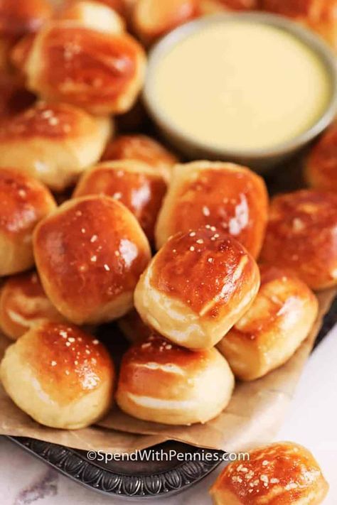 Pretzel bites are the ultimate party dipper. Fluffy on the inside and crusty and toasted on the outside, these snacks are always a hit. Homemade pretzel bites are created with a yeast dough that’s cut into bite-sized pieces and boiled and baked until fluffy and golden brown. Sprinkle with salt crystals or roll in cinnamon sugar. Serve with beer and honey mustard or cheese sauce for dipping. #pretzelbites #spendwithpennies #pretzelbitesrecipe #pretzelbiteswithcheesesauce Crescent Dogs, Honey Mustard Dip, Cucumber Onion, Homemade Pretzels, Homemade Beer, Cucumber Avocado, Spend With Pennies, Homemade Bagels, Onion Salad