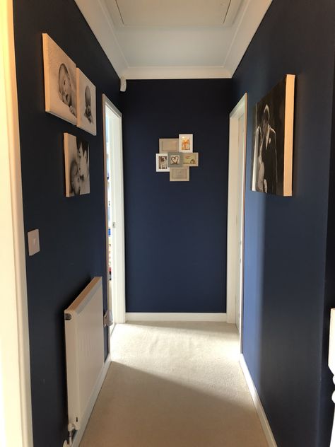 Finished hallway, navy walls, white woodwork, canvas prints Painted Door Frames Hallway, Hallway Blue Walls, Navy Hallway Ideas, Blue Hallway Paint, Small Upstairs Hallway Ideas, Blue Hallways, Navy Blue Hallway, Dark Blue Hallway, Small Upstairs Hallway