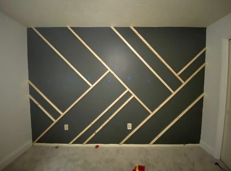 Give your wall some dramatic character with this easy to-do accent wall! Paint the wall I started by painting the wall and the baseboard with the color intended for the whole wall. Mark the studs Using a stud finder, we marked where all the studs in the wall were using blue painter's tape. Cut your wood We used 1"x2" furring strips. We measured the length of the wall where we wanted to place the first piece of wood. I recommend doing your longest lines first. Cut both ends… Dramatic Character, Pola Cat Dinding, Installing Wainscoting, Hiasan Dalaman Rumah, Tape Wall, Stud Finder, Accent Wall Designs, Accent Wall Paint, Bedroom Wall Designs