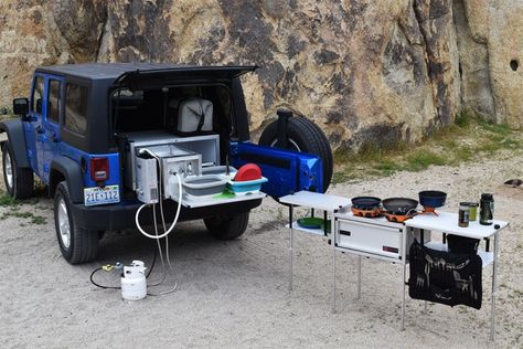 Driving to the campsite? Take everything—including the kitchen sink—with you, even if you’re just traveling in a small SUV.  California-based Trail Kitchens offers an all-in-one, sliding storage system that accommodates dishes, cookware, prep surfaces, water tank, and more. The whole unit weighs just over 100 pounds. Suv Kitchen, Camp Kitchen Organization, Jeep Wrangler Camping, Subaru Wagon, Overland Build, Kitchen Work Station, Kitchen Utensil Rack, Pull Wagon, Kitchen Setup