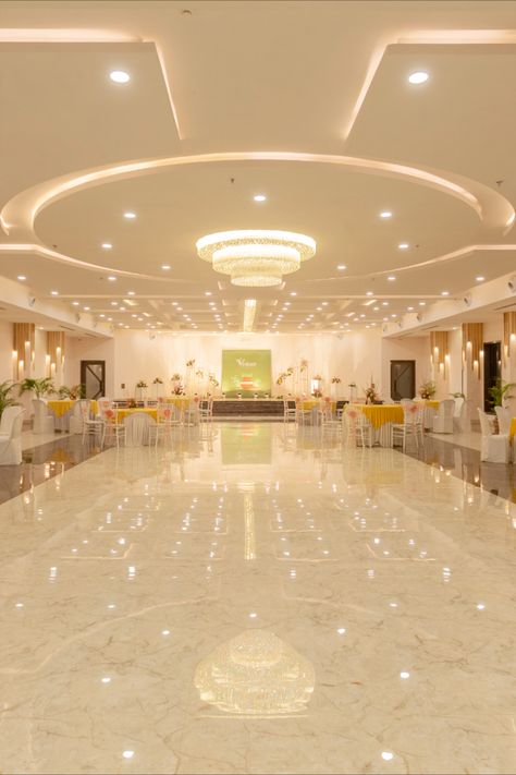 The Main entrance opens up to a grand banquet hall which is a dedicated ritual area for Indian ceremonies, a pillar-free ballroom with a 14 ft high ceiling for the perfect wedding ambience. The interiors of the main hall were designed around the ceiling. Ceiling Design Banquet Hall, Banquet Hall Floor Tiles Design, Birthday Party Hall Interior Design, Wedding Halls Designs, Wedding Hall Background, Wedding Hall Design Interior, Marriage Hall Ceiling Design, Wedding Hall Ceiling Design, Banquet Hall False Ceiling Design