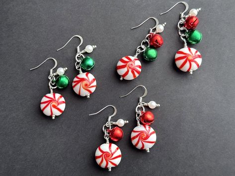 Fun lampwork glass peppermints dangle beneath your choice of jingle bells in green, red, or both in this handmade pair of earrings in fun Christmas theme when set upon silver plated earring hooks. Single Bell Earring Length: 46mm (including earring hook)  Double Bell Earring Length: 50mm (including earring hook) I also have more holiday themed items here: http://etsy.me/1MX5SUb Want to see More? Visit my shop! http://gilliauna.etsy.com © Bits n' Beads by Gilliauna (gilliauna@gmail.com) Shop Poli Christmas Jewelry Display Ideas, Christmas Earrings Beads, Peppermint Earrings, Diy Grinch Earrings, Christmas Tree Earrings Diy, Jingle Bell Earrings, Diy Christmas Earrings Ideas, Christmas Wire Wrapped Jewelry, Handmade Christmas Earrings