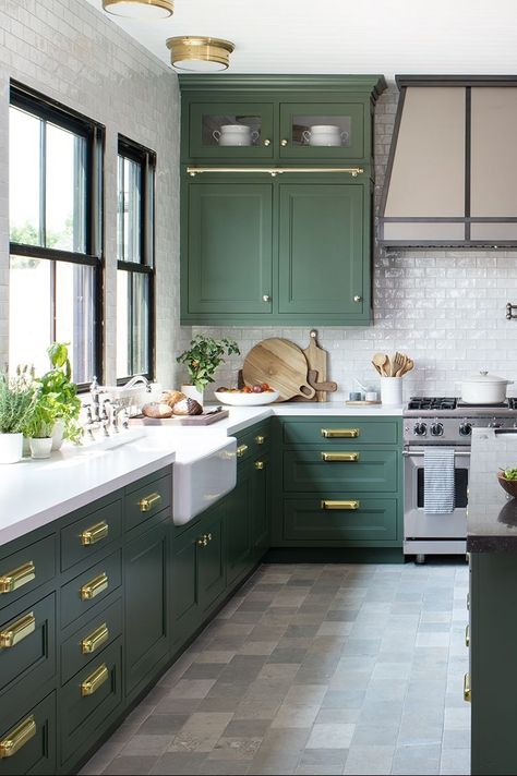 a kitchen with green cabinets and stone floors Sage Kitchen Flooring Ideas, Green Kitchen Cabinets With Tile Floor, Green Kitchen With White Cabinets, Herringbone Floor Kitchen, Kitchen With Green Cabinets, Grey Tile Kitchen Floor, Concrete Kitchen Floor, Grey Kitchen Tiles, Kitchen Flooring Ideas