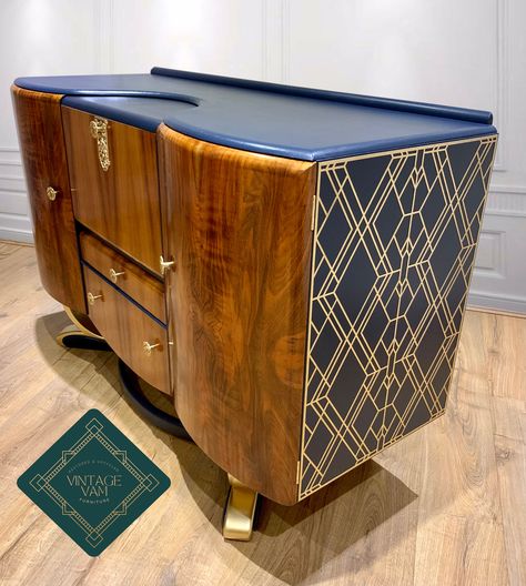 1952 Cocktail cabinet by Beautility. The Walnut doors and drawers have been stripped back, sanded and finished in Osmo. The rest of the cabinet has been finished in Fusions Midnight Blue and Gold. An Art Deco panel has been added to the outer sides. The same panel along with new Glass, mirrors and an auto sensor light have been fitted in the Cocktail compartment. A matching paper to the panels has been applied to the rear walls of the cupboards. As with all Vintage furniture please expect a leve Blue And Gold Art, Midnight Blue And Gold, Art Deco Panel, Art Deco Dressing Table, Deco Panel, Art Deco Sideboard, Walnut Doors, Glass Mirrors, Cocktail Cabinet