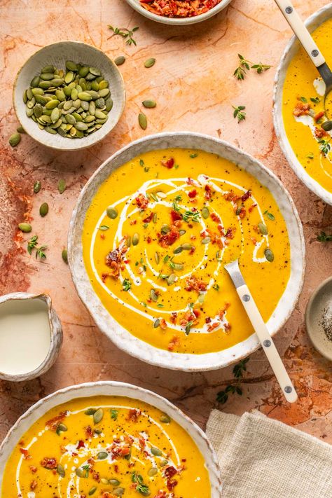 This delicious, healthy butternut squash soup recipe features a rich & creamy blend of roasted squash, garlic, chicken broth, & coconut milk. Topped with crispy chopped bacon and cilantro pumpkin seeds, this beautiful soup bursts with flavor in every bite. Paleo, Gluten-Free, Dairy Free, and Whole30. #butternutsquashsoup #souprecipes #dairyfree #paleo #soup #vitamixrecipes Non Dairy Butternut Squash Soup, Chicken And Squash Soup, Butternut Squash Soup Vitamix, Healthy Butternut Squash Soup Recipes, Paleo Butternut Squash Soup, Healthy Butternut Squash Soup, Paleo Soups, Healthy Butternut Squash, Butternut Squash Soup Recipe