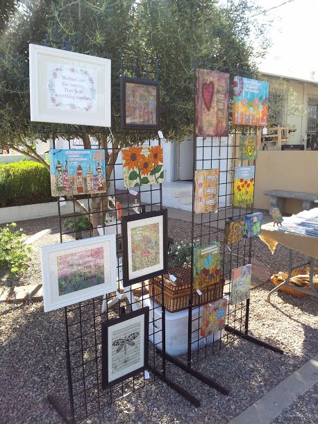 2 grids 6' tall, canvas display at craft show.  www.serendipitystudiobycw.blogspot.com Canvas Art Display Booth, Canvas Exhibition Display, Displaying Canvas Art At Craft Show, Grid Display Ideas Craft Fairs, Craft Show Painting Display, Craft Fair Displays For Wall Art, Craft Show Art Display, How To Display Canvas Art At Craft Show, Art Display Table