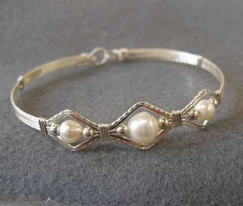 It's beautiful, it's unique, it's eye-catching. A bracelet design I call the 3-Bead Point. This one is sterling silver wire and features beautiful, natural white freshwater pearls. The hook-and-eye clasp is easy to get on and off by yourself. Pearl is a lovely and classic accessory for a bride, bridal party, flower girl... I'm happy to make this bracelet in any size you need! (Obviously the shapes of the natural pearls will vary slightly). Choose your size from the variations for a perfect fit! Silver Bracelet Aesthetic, Silver Jewelry Ideas, Bridal Jewelry Silver, Pearl Bracelet Silver, Wedding Jewelry Silver, Silver Jewellry, Silver Jewlery, Pearl Bracelet Wedding, Bracelet Wedding