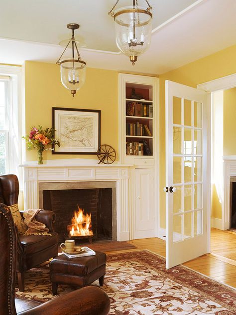 White millwork, soft yellow walls, honey wood floors, cognac leather wing chairs: this is my Dream Room!! Yellow Walls Living Room, Leather Wing Chair, Yellow Cottage, Yellow Room, Yellow Living Room, Brown Furniture, Room Paint Colors, Design Apartment, Yellow Walls