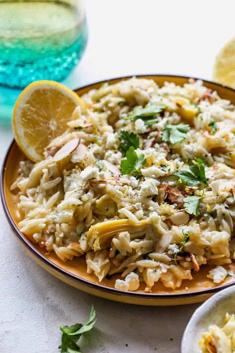 This easy Lemon Orzo Salad is filled with artichokes, feta, and almonds, and comes together in under 30 minutes. Enjoy as a vegetarian lunch, or pair with white fish for a light and bright spring dinner. #orzorecipes #orzosalad #saladrecipes #orzopastasalad Artichoke Orzo Recipes, Chicken Orzo Salad Recipes, Salad Artichoke Hearts, Orzo Artichoke, Lemon Feta Orzo, Salad Artichoke, Artichoke Orzo, Protein For Dinner, Salad With Artichokes