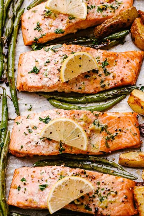 Simple, fresh, and flavorful, this baked salmon recipe with potatoes and green beans is one of my family's favorite sheet pan dinners. The buttery garlic lemon sauce is really spectacular, and it's done in 30 minutes! Simple Salmon Recipes Baked, Sheet Pan Salmon And Asparagus, Salmon In The Oven Easy, Baked Salmon Recipes Oven, Sheet Pan Salmon And Veggies, Salmon Sheet Pan Dinner, Sheet Pan Dinners Healthy, Salmon Green Beans, Salmon In The Oven