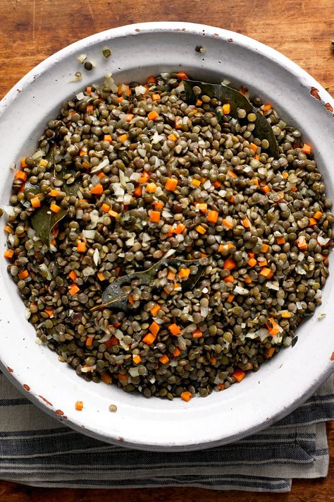 NYT Cooking: This is a classic French way to cook lentils, and it’s very easy. Aromatics are sautéed and then simmered with French lentils, also known as Le Puy lentils, for 20 to 25 minutes. It is an easy side dish (shown here with <a href="http://cooking.nytimes.com/recipes/8174-cod-baked-with-prosciutto">cod baked with prosciutto</a>), redolent of a Provencal feast. Green Lentil Recipes, Cook Lentils, Puy Lentils, French Green Lentils, Thyme Recipes, French Lentils, How To Cook Beans, Green Lentils, Nyt Cooking