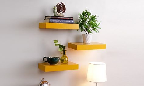 Floating Wall Shelf (Set of 3) in Yellow Finish | Decorate your walls with these well designed and ergonomic wall shelves. Available in a variety of styles and designs, you can use them to organise your essentials or display decorative items Shelves Furniture, Furniture Shops, Floating Wall Shelf, Shelf Furniture, Furniture Packages, Floating Wall Shelves, Furniture Market, Wooden Shelf, Yellow Walls