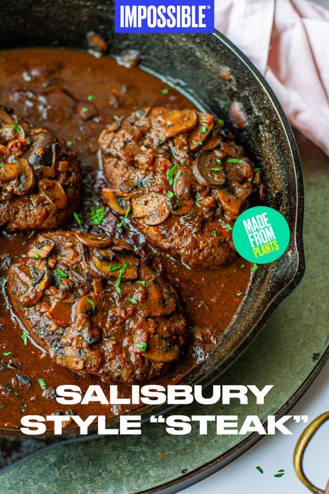 This Impossible™ Salisbury-Style “Steak” recipe is the meatier, grown-up version of this classic dish. The recipe calls for Impossible™ Burger steaks, smothered in a rich umami mushroom gravy that will have your entire family craving a second serving. Hearty, tender, and flavorful – it's the perfect way to end the evening! Find more recipes from Meiko on at @meikoandthedish! Impossible Steak Recipe, Impossible Salisbury Steak, Vegan Salisbury Steak Beyond Meat, Vegetarian Salisbury Steak, Grown Beef Recipes Dinners, Vegan Cubed Steak, Vegan Salsberry Steak Recipe, Plant Based Steak Recipes, Vegetarian Steak Alternative