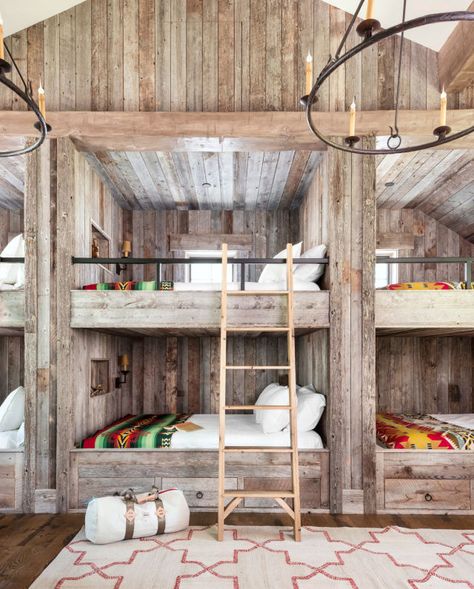 This bunk bed room may fit a ton of guests to this cabin, but it also has a cozy feel thanks to functional built-ins and wrought-iron railing. Instead of traditional twin- size bunk beds, the homeowners decided to build six queen-size versions. The room also contains two twin beds, bringing the sleeping total in this space alone to 14 people. Talk about a slumber party! Bunk Room Ideas, Bunk Bed Room, Bunk Bed Rooms, Modern Bunk Beds, Built In Bed, Bunk Rooms, Built In Bunks, Log Cabin Decor, Bunk Room